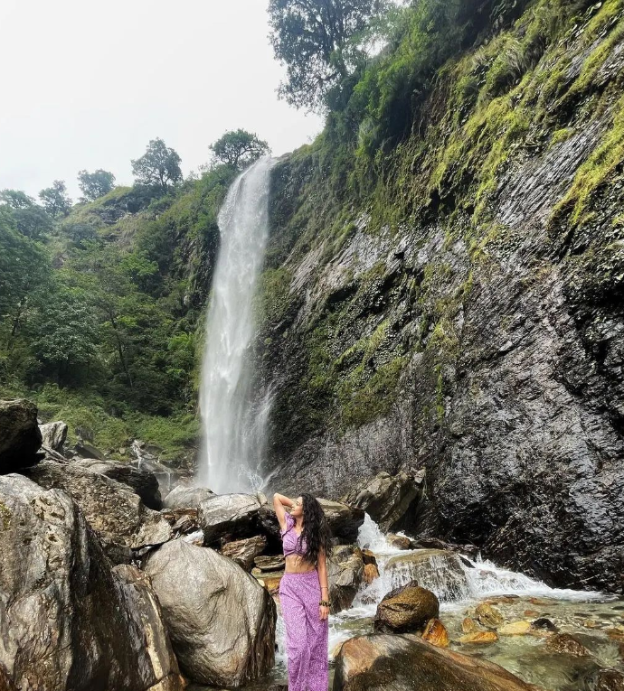 girl standing near birti fall in munsiyari
